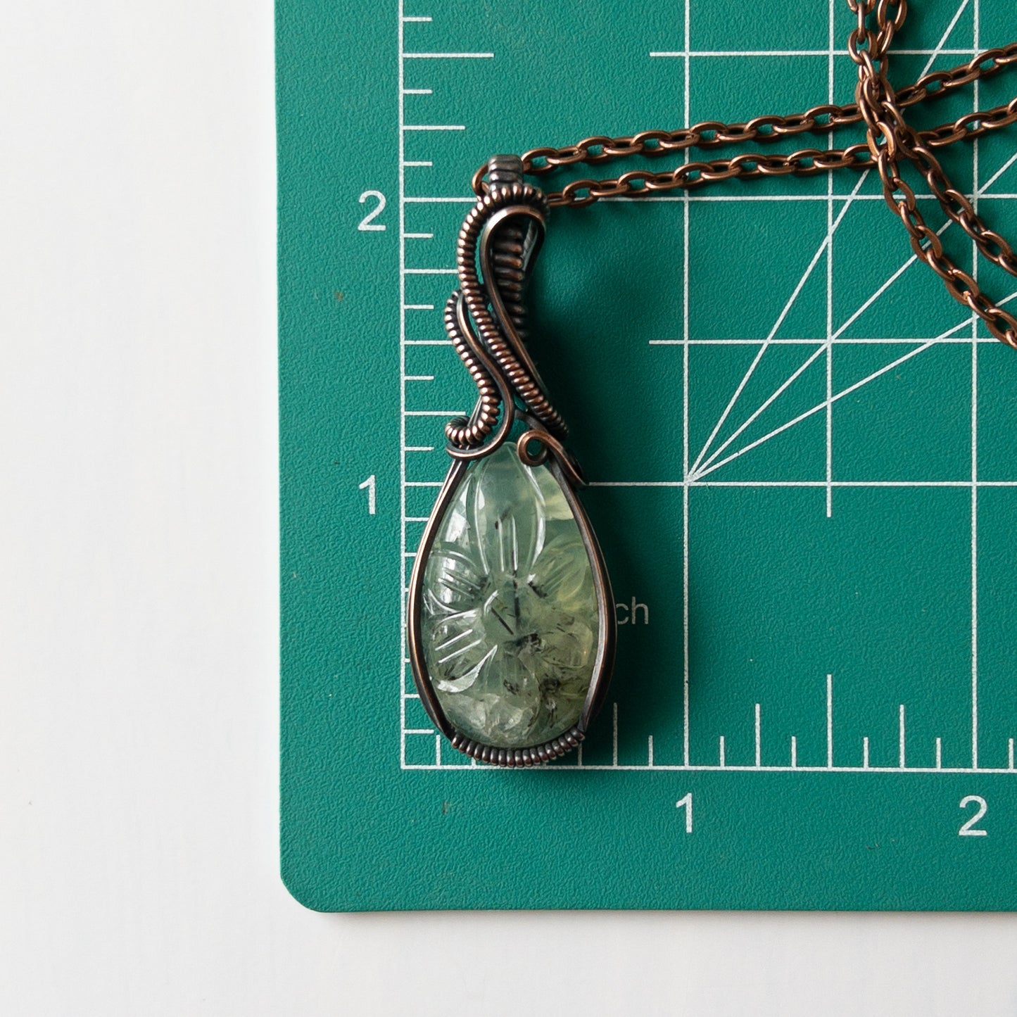 Prehnite With Carved Flower Motif & Copper Wrapped Pendant