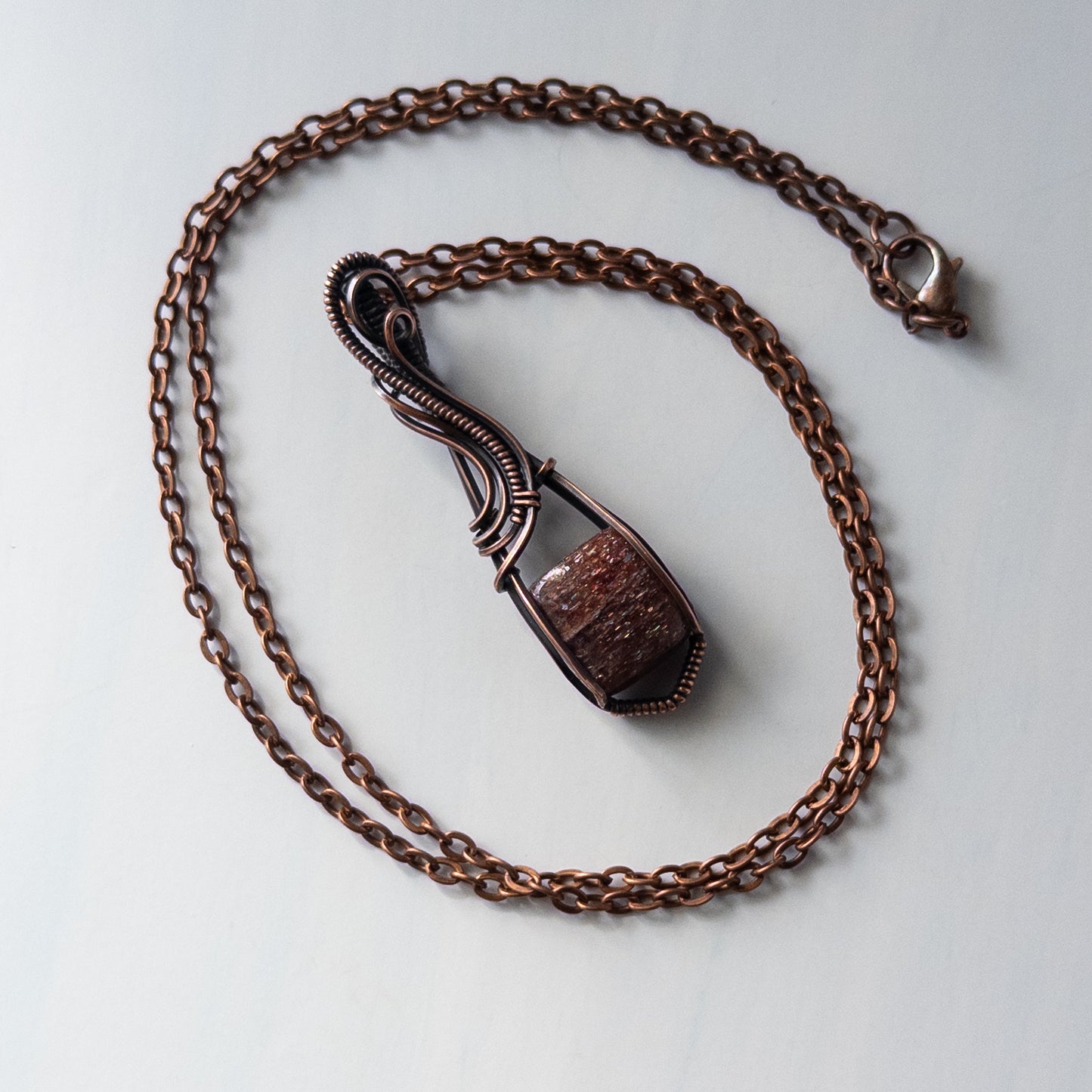 Bloodshot Iolite Sunstone Antiqued Copper Wrapped Pendant