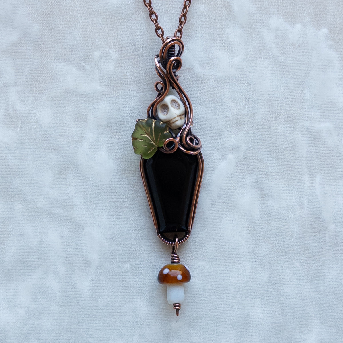 Obsidian Coffin Antiqued Copper Pendant With Skull, Leaf, & Dangling Glass Mushroom