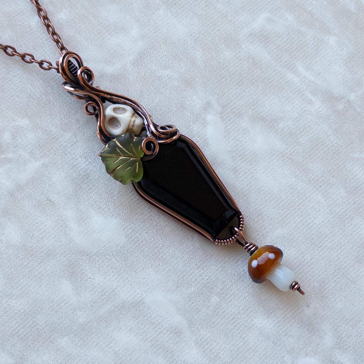 Obsidian Coffin Antiqued Copper Pendant With Skull, Leaf, & Dangling Glass Mushroom