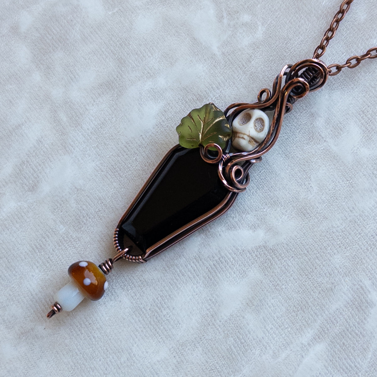 Obsidian Coffin Antiqued Copper Pendant With Skull, Leaf, & Dangling Glass Mushroom