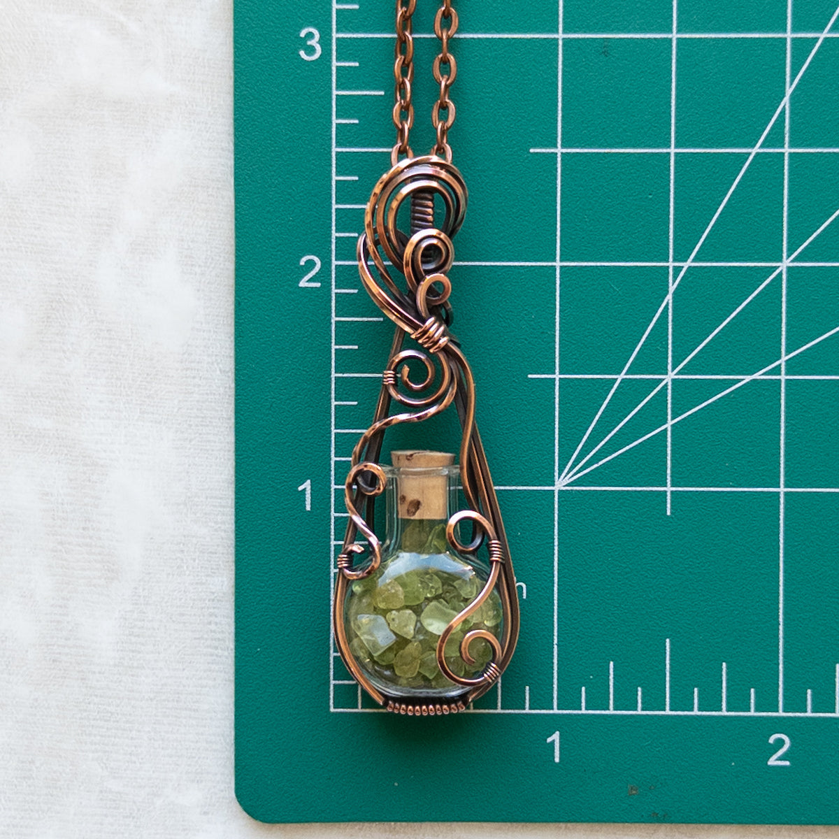 Peridot Filled Glass Bottle Antiqued Copper Pendant