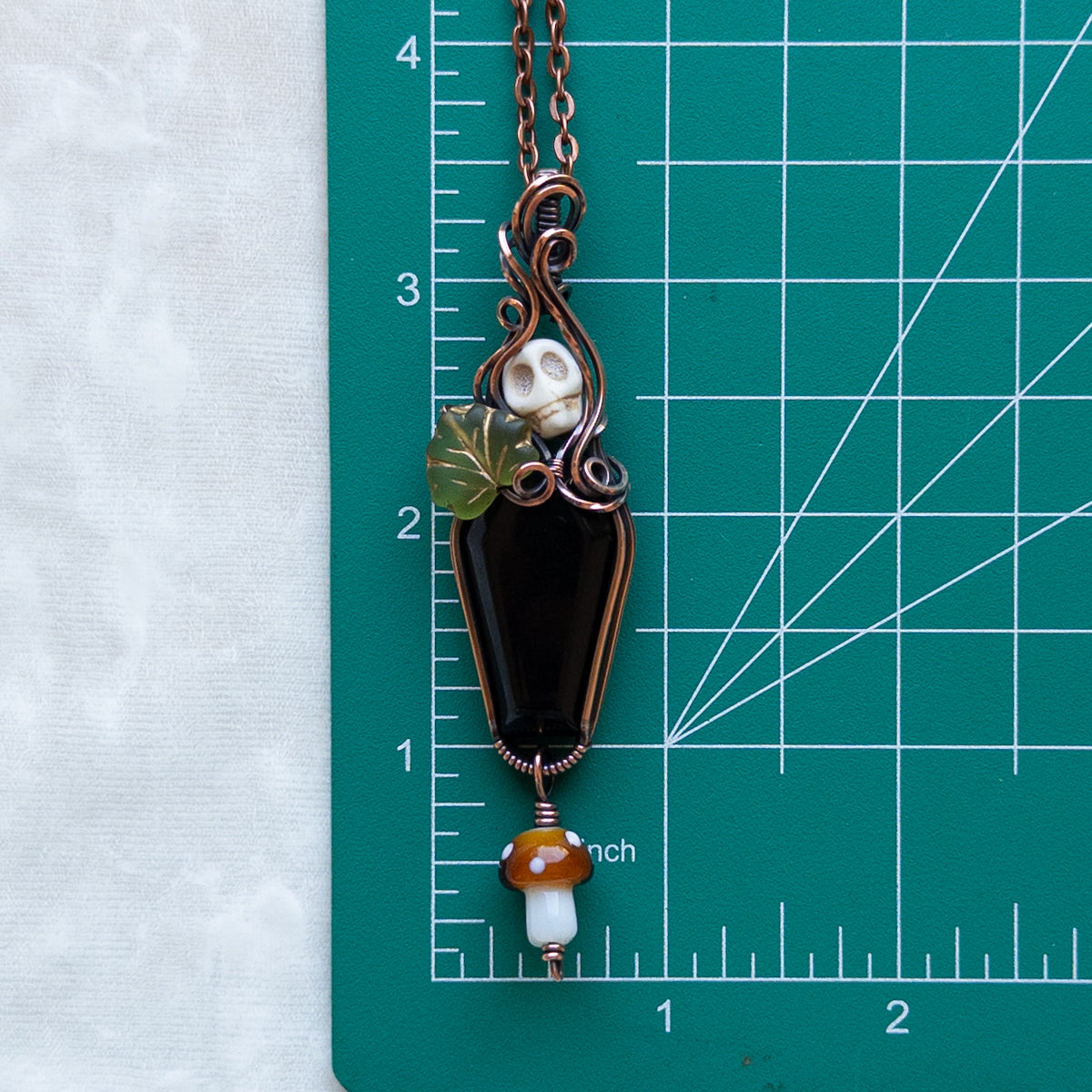 Obsidian Coffin Antiqued Copper Pendant With Skull, Leaf, & Dangling Glass Mushroom