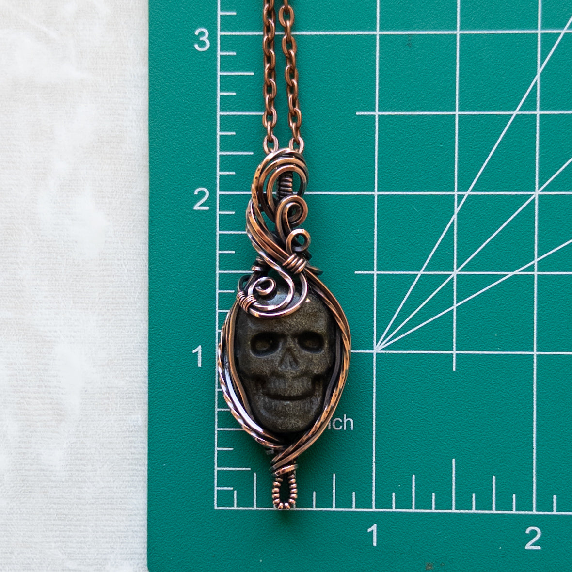 Silver/Gold Sheen Obsidian Skull Antiqued Copper Pendant